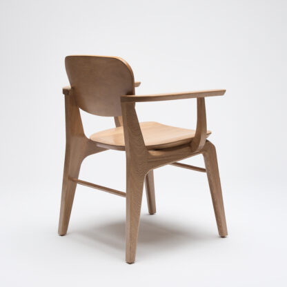 silla moderna de madera con descansabrazos y con asiento de madera vista desde atrás